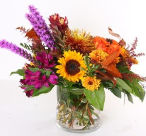 Sunflowers and pink and purple flowers in vase