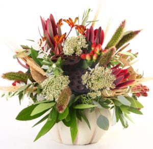 red and green florals in white vase