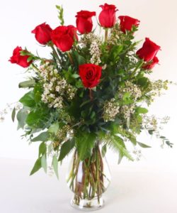 One dozen of the finest Ecuadorian roses carefully hand selected and arranged in all their natural beauty in a glass vase. Standard will be accented with baby's breath,