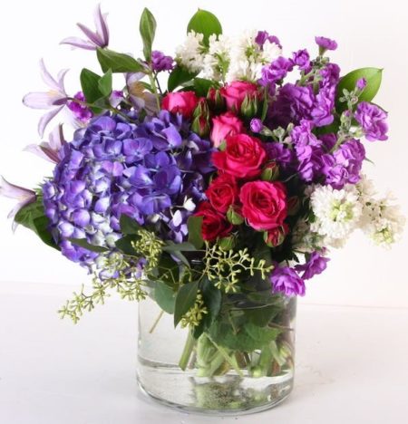 Think spring- lilacs, hydrangea, stock, spray roses and more are included in this beautiful vase arrangement.