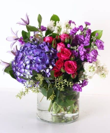Think spring- lilacs, hydrangea, stock, spray roses and more are included in this beautiful vase arrangement.