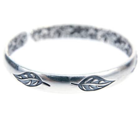 Silver bracelet with leaves design isolated on white background. Silver bracelet or bangle with leaf pattern carving style