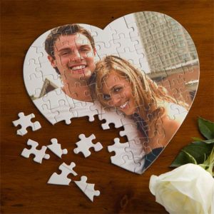 heart-shaped puzzle with couple hugging